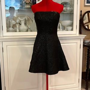 Black brocade strapless swing dress.